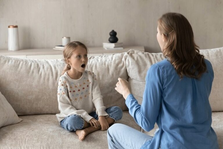 Parent supporting a child with speech therapy activities at home.